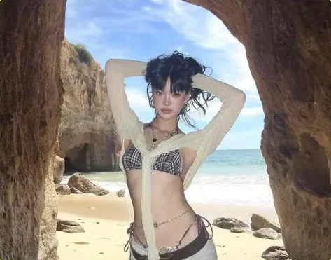 Editorial beach shot under a rock arch
